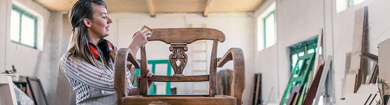 woman upholstering a chair woman upholstering a chair