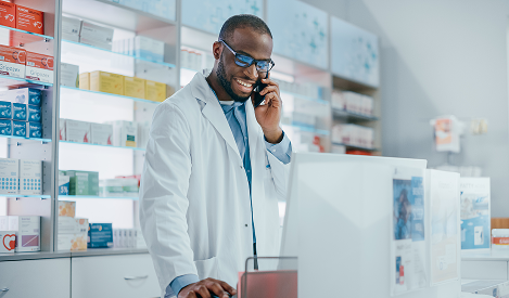 Pharmacist consulting with a patient by phone about prescription medications