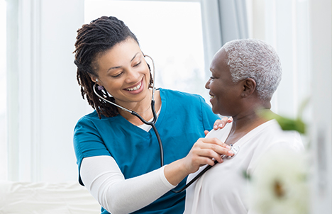 Female Doctor with Female Patient Listening to Breathing