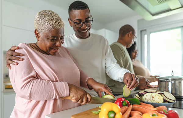 mom son cutting vegetables in kitchen