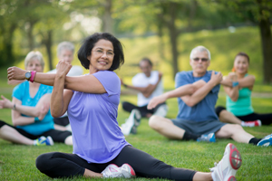 Group of people stretching outside