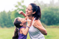 Mom and daughter flexing arms